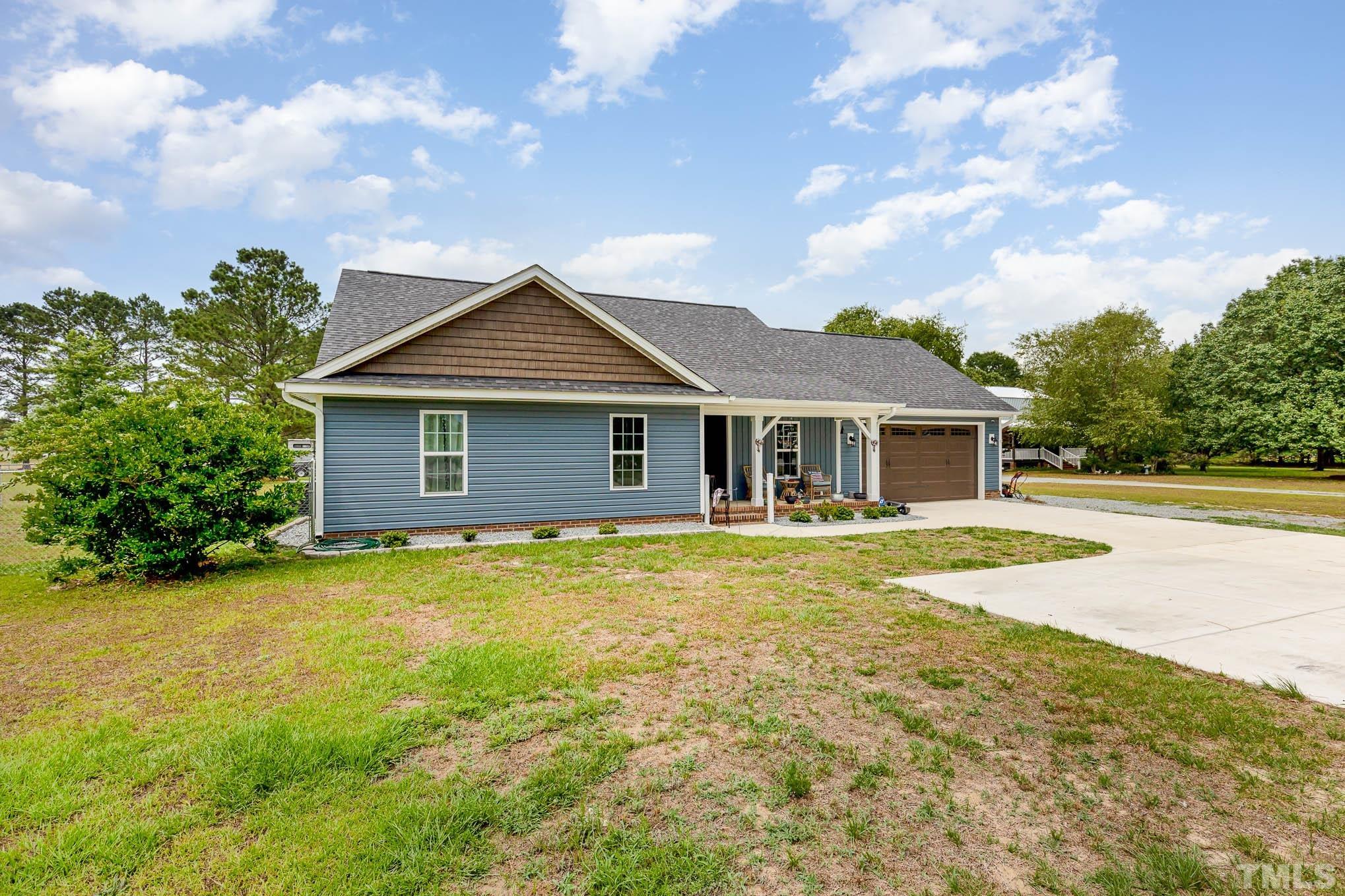 6551 Faircloth Bridge Road Stedman, NC 28391 - Photo 3 of 30 a front view of house with yard and swimming pool