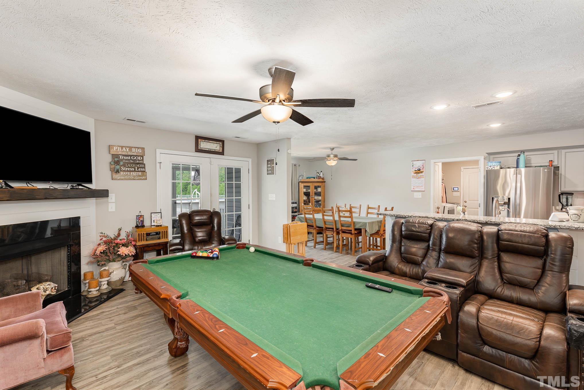 6551 Faircloth Bridge Road Stedman, NC 28391 - Photo 8 of 30 a living room with furniture a flat screen tv and a fireplace