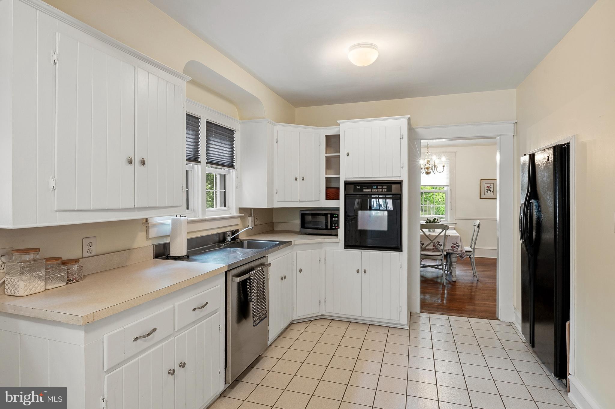 5952 Old Washington Road Elkridge, MD 21075 - Photo 12 of 43 a kitchen with white cabinets and stainless steel appliances