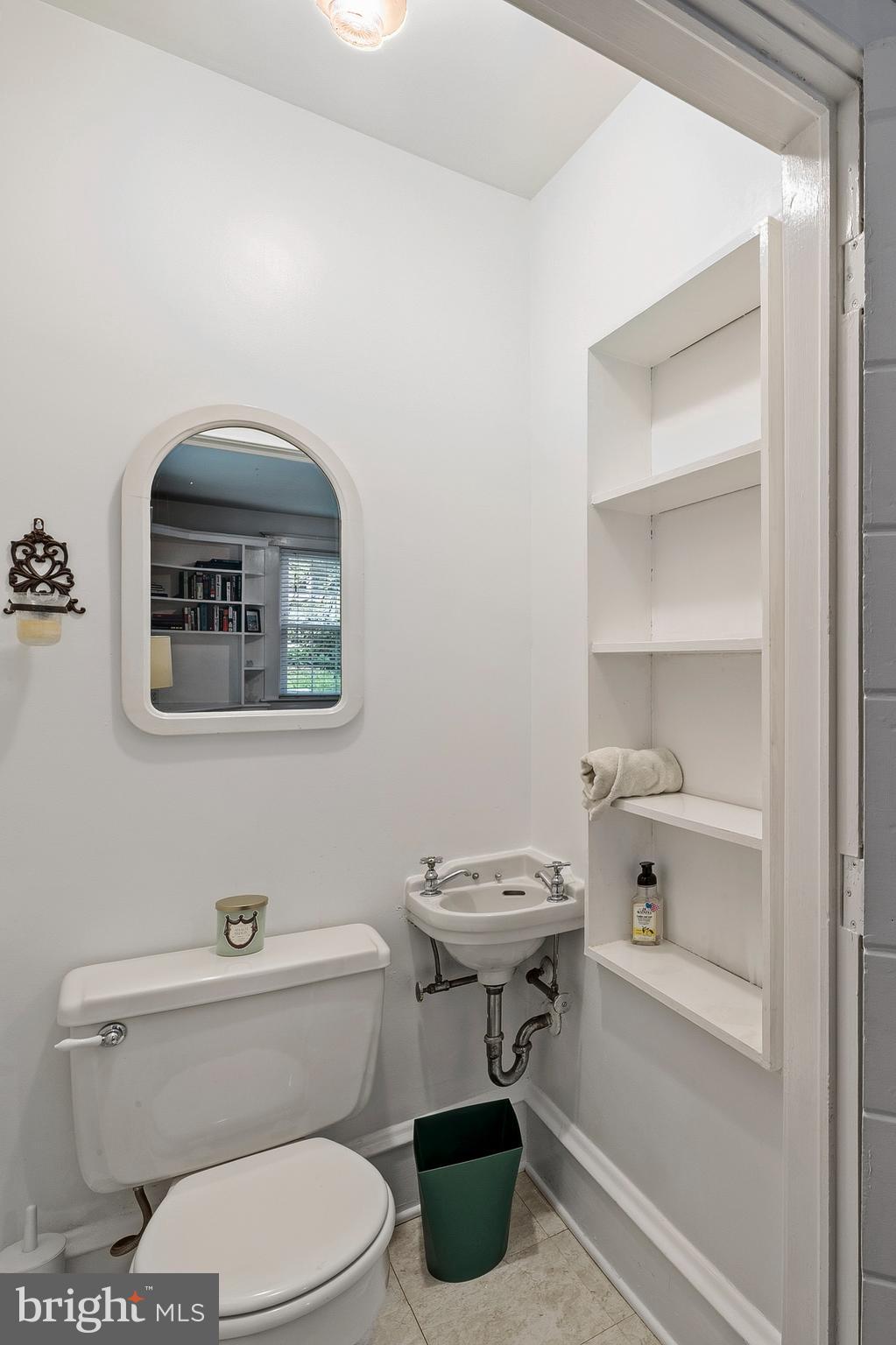 5952 Old Washington Road Elkridge, MD 21075 - Photo 16 of 43 a white toilet sitting next to a bathroom sink