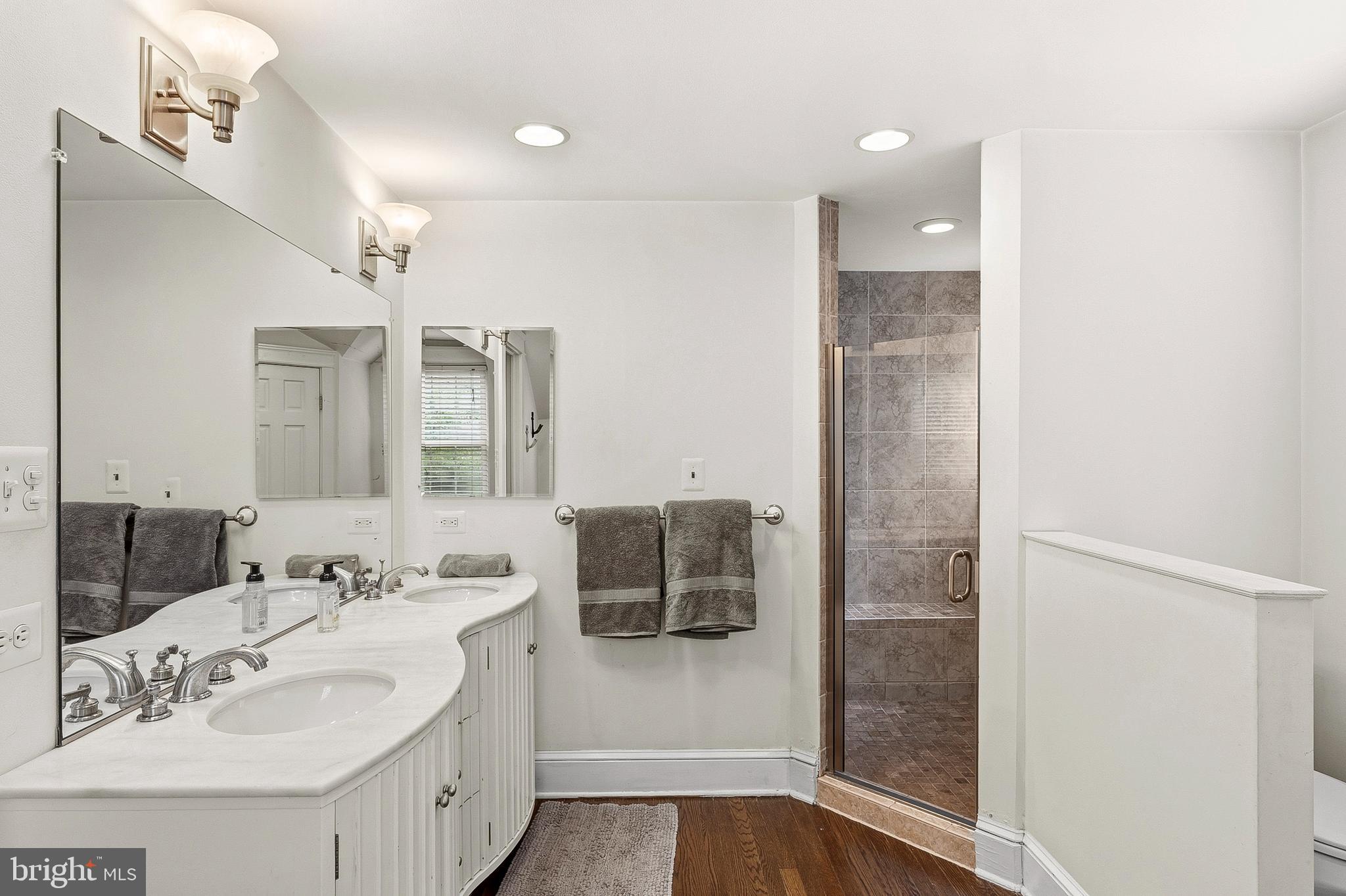 5952 Old Washington Road Elkridge, MD 21075 - Photo 24 of 43 a bathroom with a shower sink and mirror