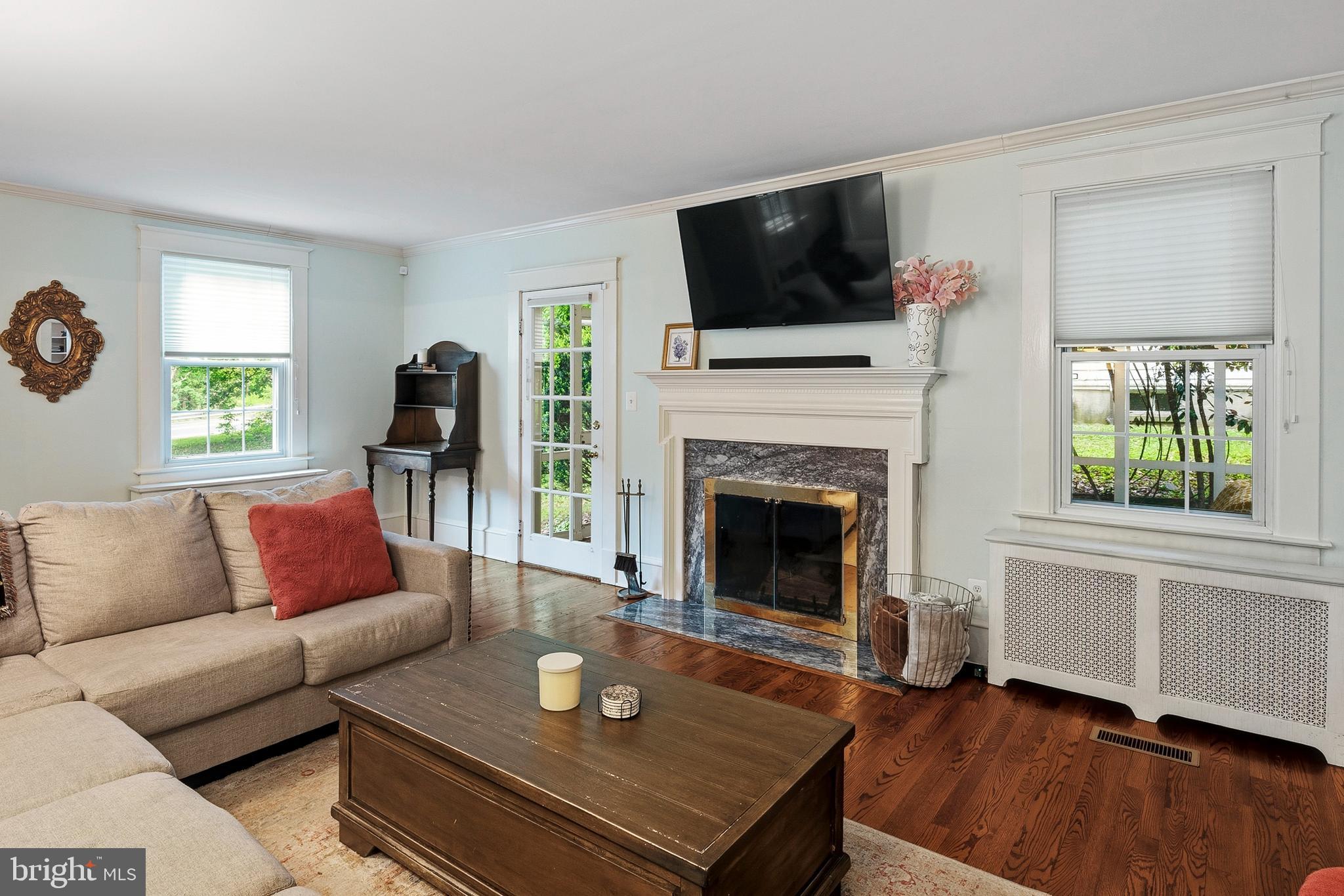 5952 Old Washington Road Elkridge, MD 21075 - Photo 5 of 43 a living room with furniture a fireplace and a flat screen tv