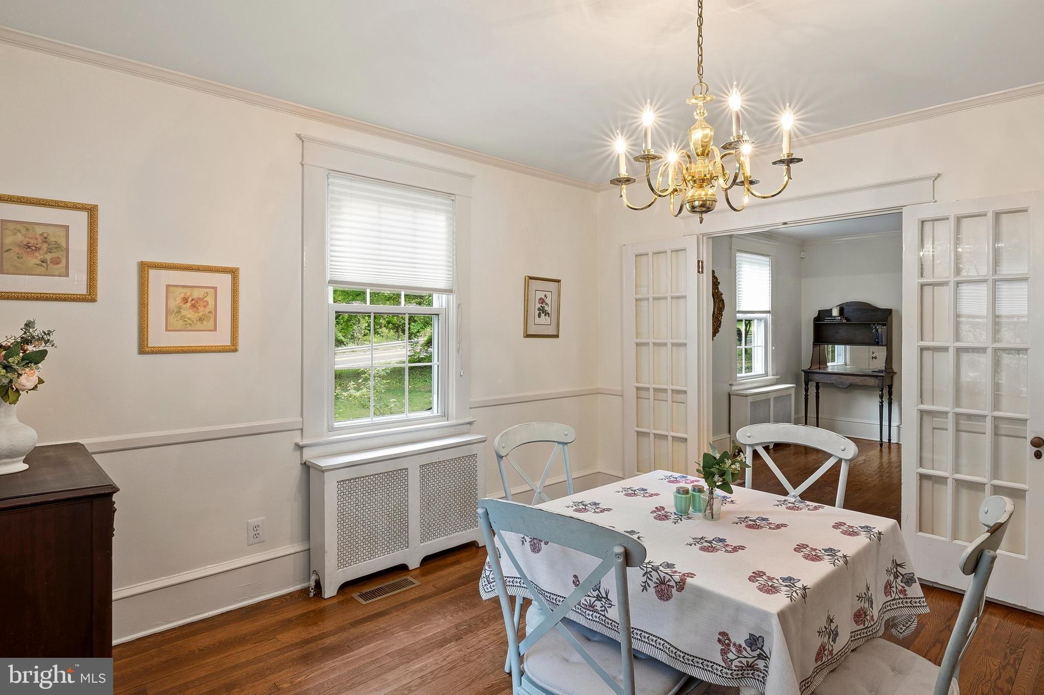 5952 Old Washington Road Elkridge, MD 21075 - Photo 9 of 43 a view of a dining room with furniture a chandelier and wooden floor