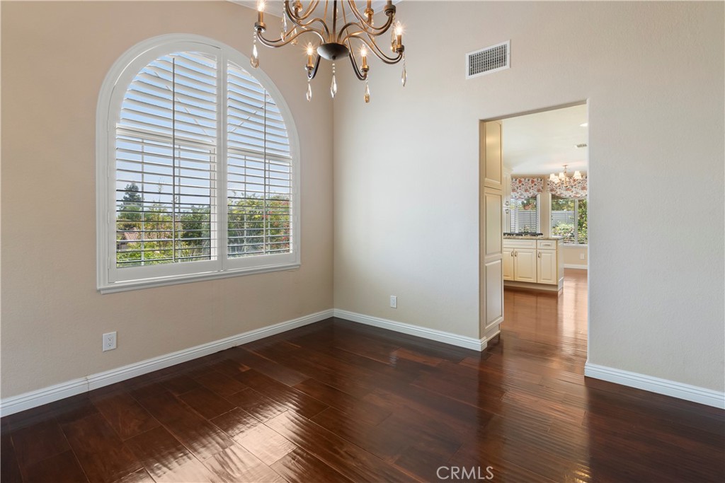 6717 Mission Grove Parkway North Riverside, CA 92506 - Photo 14 of 58 a view of an empty room with wooden floor and a window