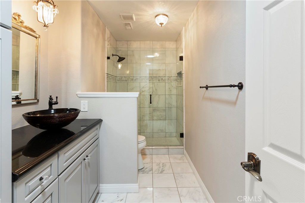 6717 Mission Grove Parkway North Riverside, CA 92506 - Photo 24 of 58 a bathroom with a sink a toilet and shower