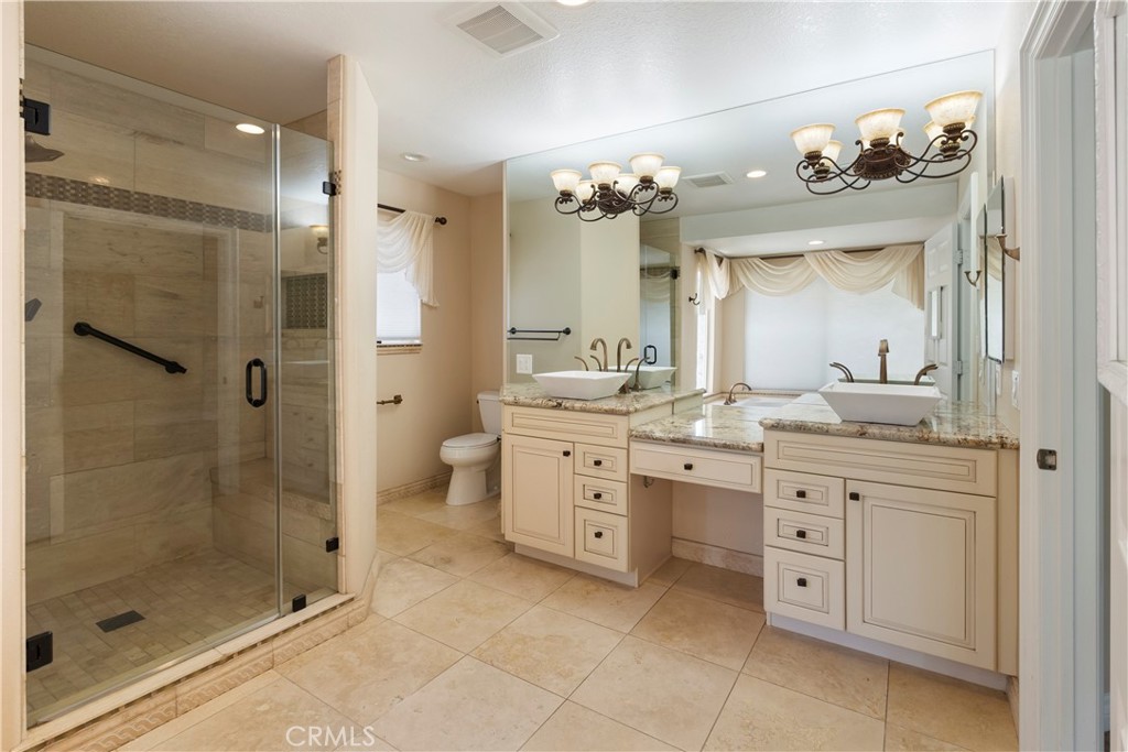 6717 Mission Grove Parkway North Riverside, CA 92506 - Photo 30 of 58 a bathroom with a double vanity sink mirror and a shower