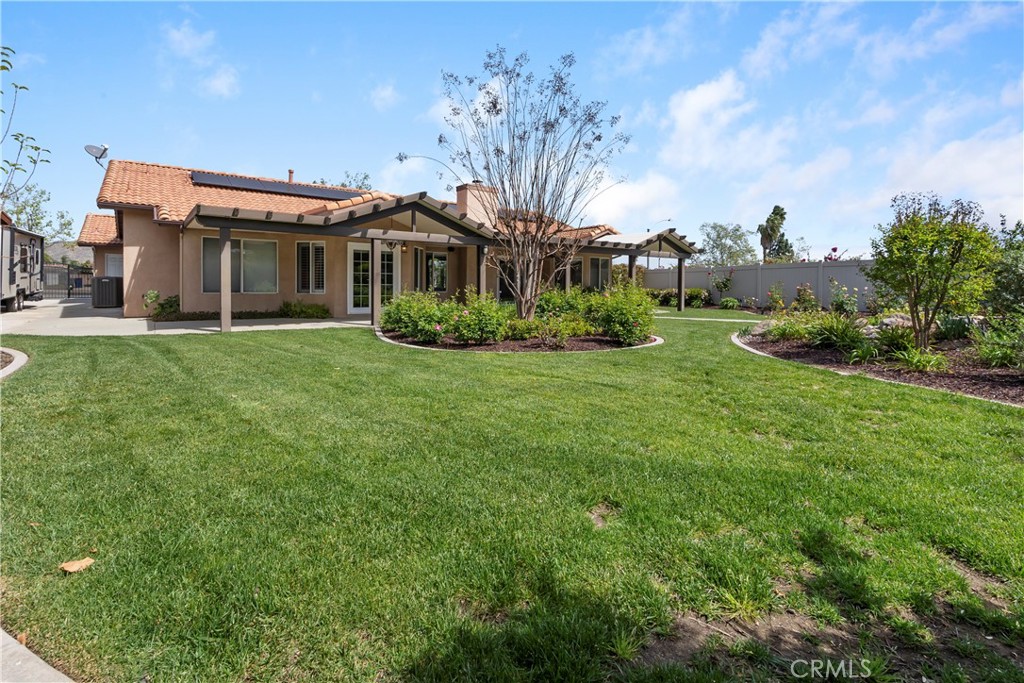 6717 Mission Grove Parkway North Riverside, CA 92506 - Photo 37 of 58 a front view of a house with garden and trees
