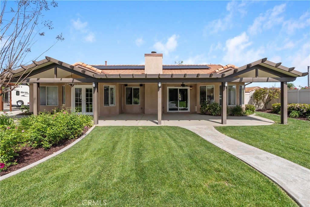 6717 Mission Grove Parkway North Riverside, CA 92506 - Photo 47 of 58 a front view of a house with yard and green space