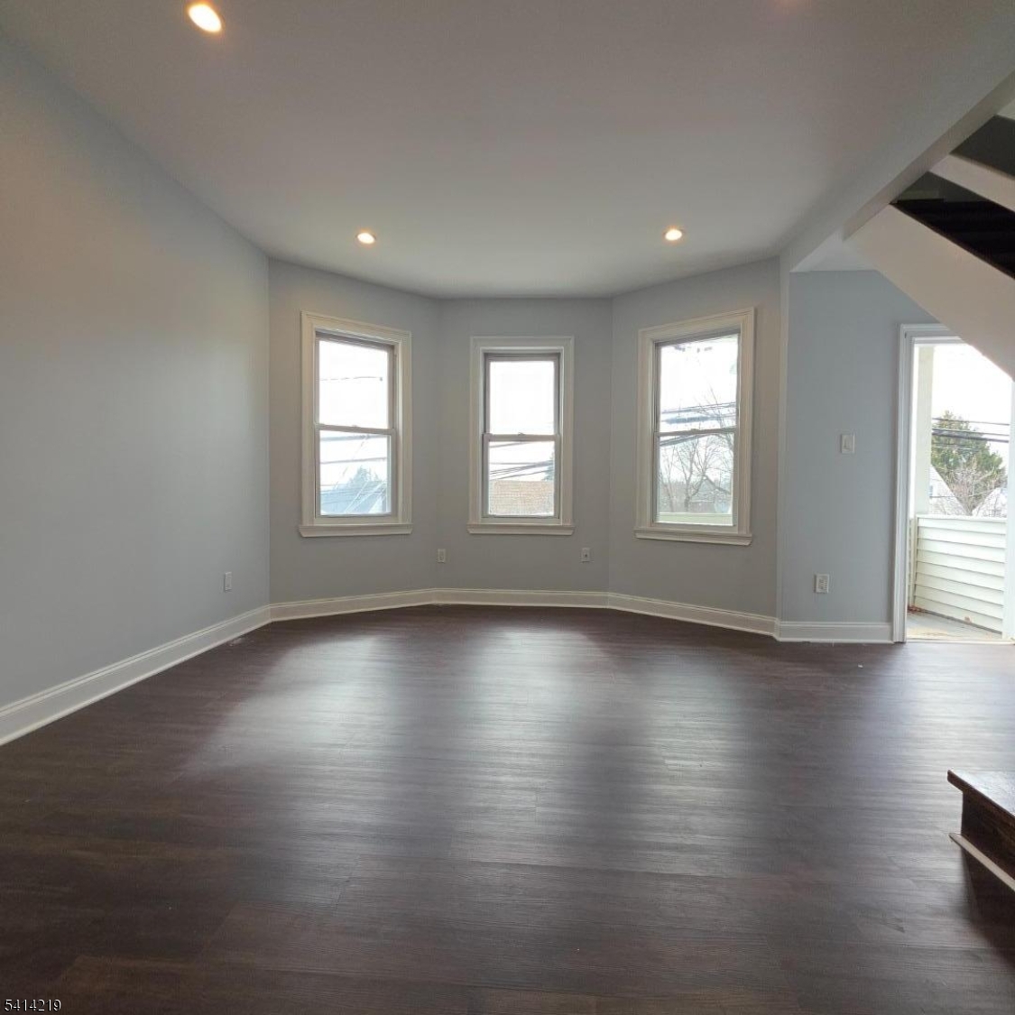 322 Rutherford Boulevard Clifton, NJ 07014 - Photo 2 of 8 an empty room with wooden floor and windows