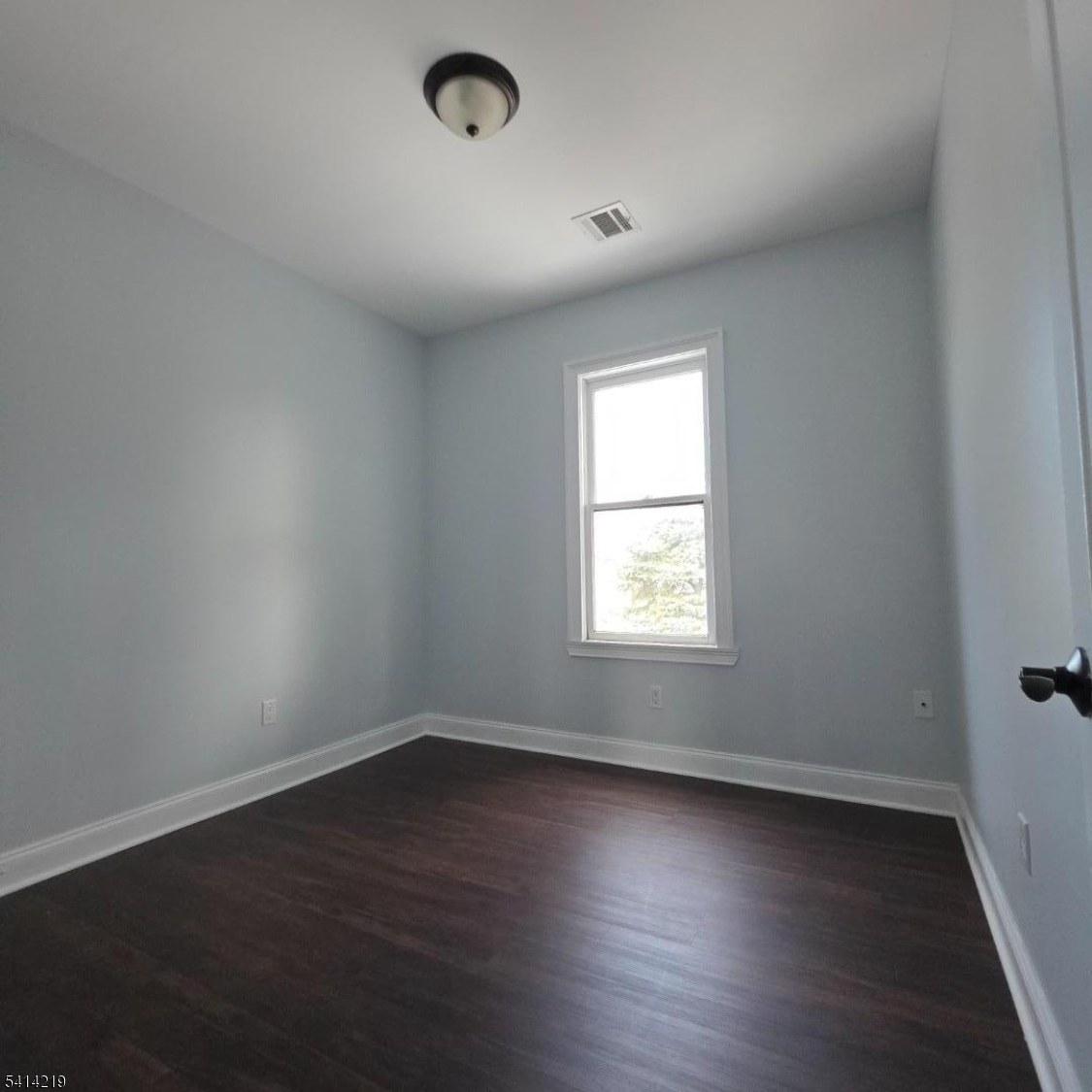 322 Rutherford Boulevard Clifton, NJ 07014 - Photo 4 of 8 an empty room with wooden floor and windows