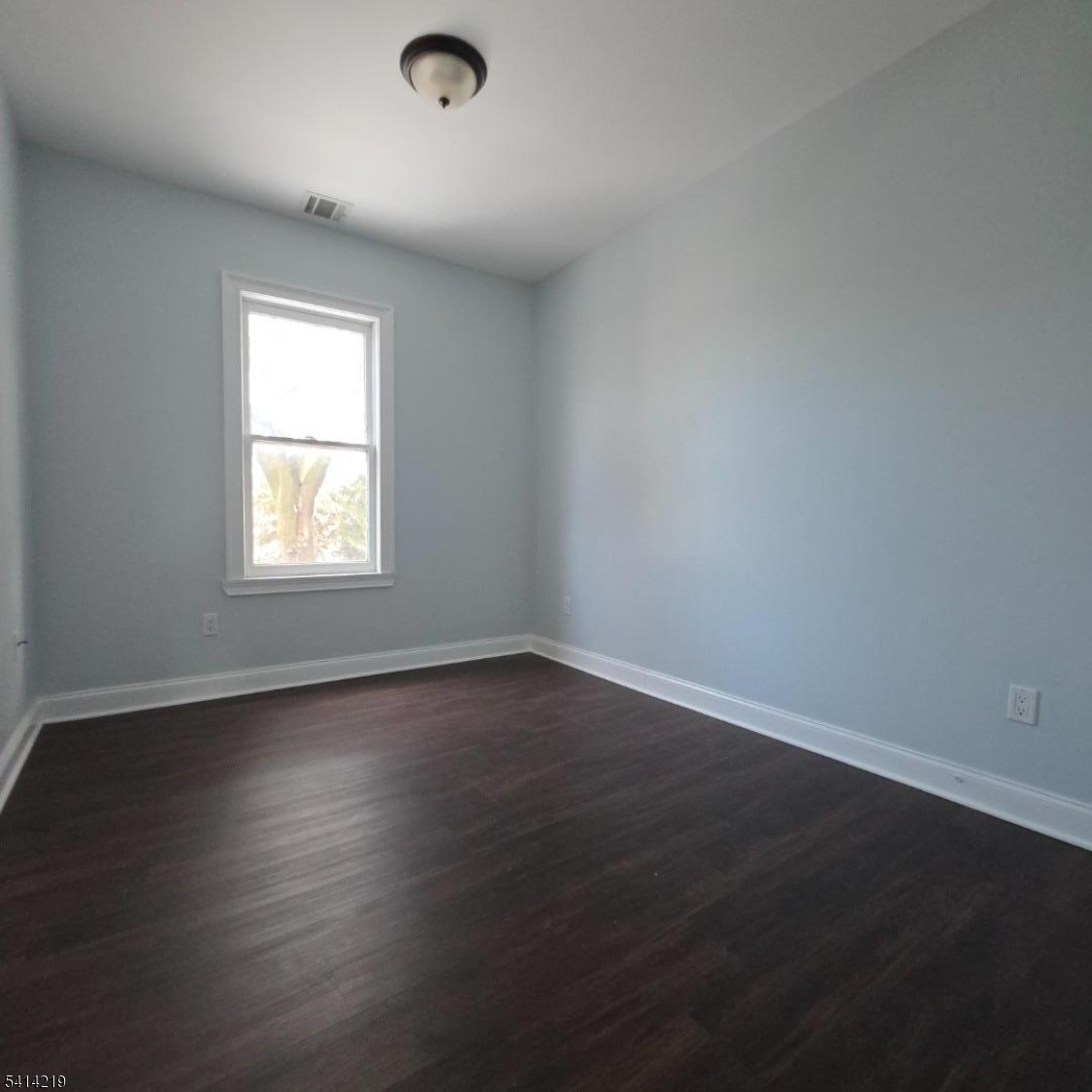 322 Rutherford Boulevard Clifton, NJ 07014 - Photo 5 of 8 an empty room with wooden floor and windows