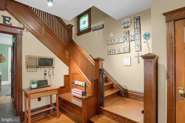 a view of entryway livingroom and hall with wooden floor