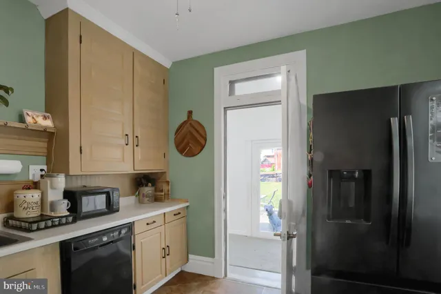 a kitchen with a refrigerator and a stove top oven