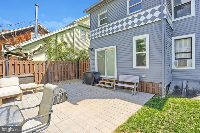 a view of a house with backyard porch and sitting area