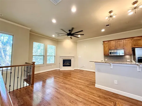 a view of a kitchen with a stove wooden floor and a kitchen