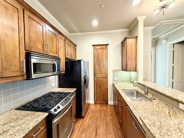 a kitchen with a stove a sink and a refrigerator