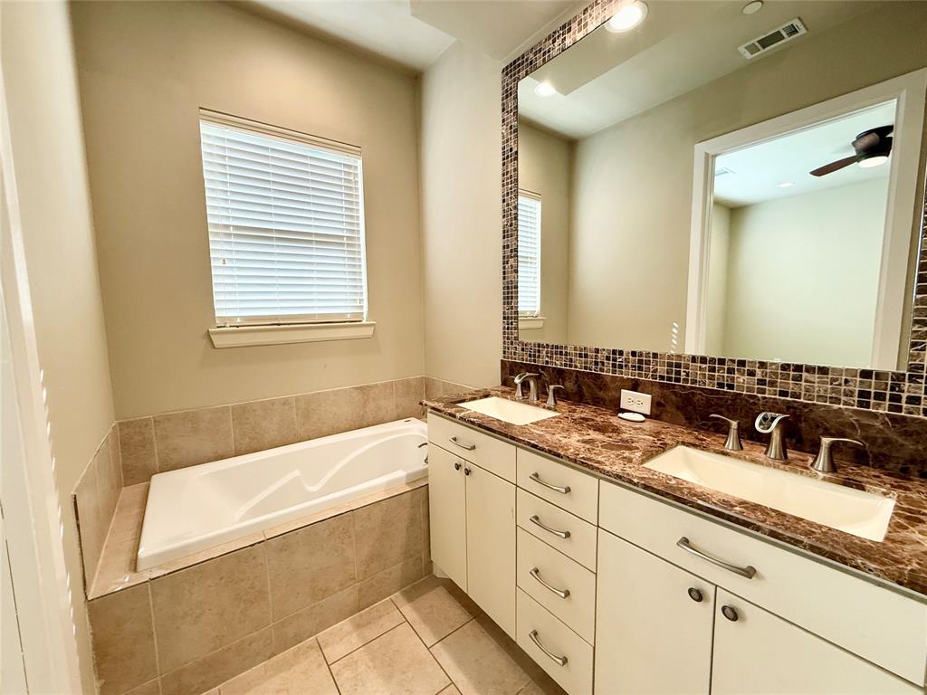 7333 Valley View Lane, Unit 101 Dallas, TX 75240 - Photo 6 of 7 a bathroom with a granite countertop tub sink and mirror