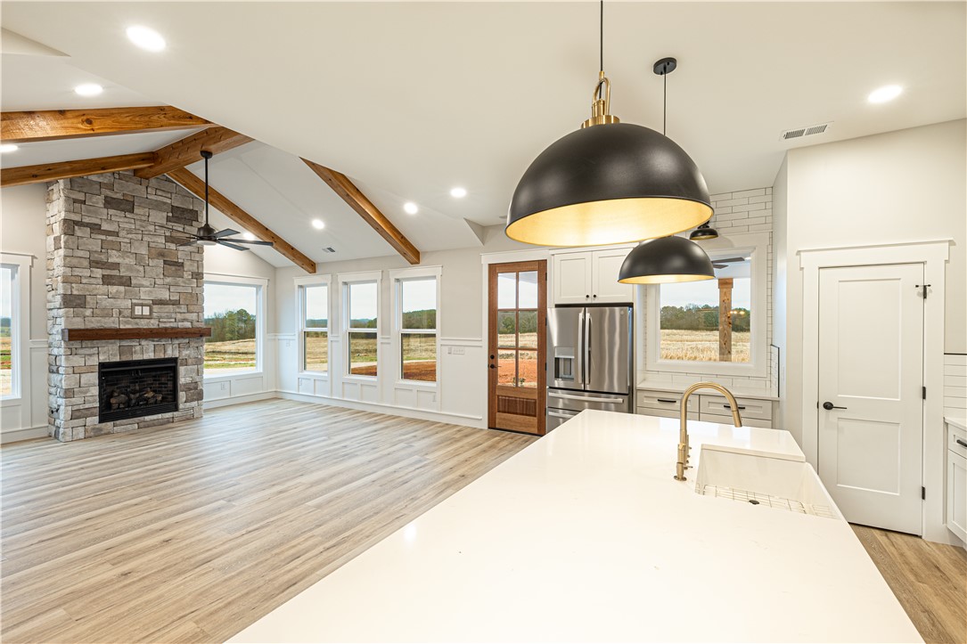 110 Hart Road Anderson, SC 29621 - Photo 20 of 31 This bright and airy living space features a stone fireplace and a spacious kitchen island.