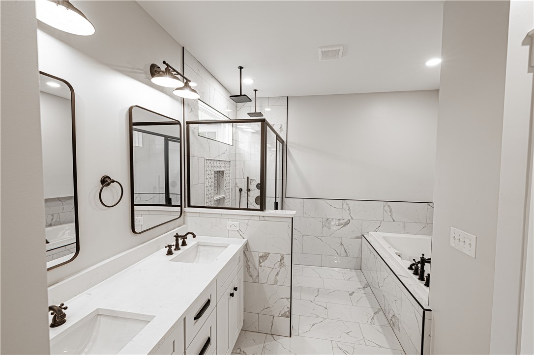 110 Hart Road Anderson, SC 29621 - Photo 2 of 31 This spacious primary bathroom features a dual vanity, sleek tile flooring, and a walk-in shower.