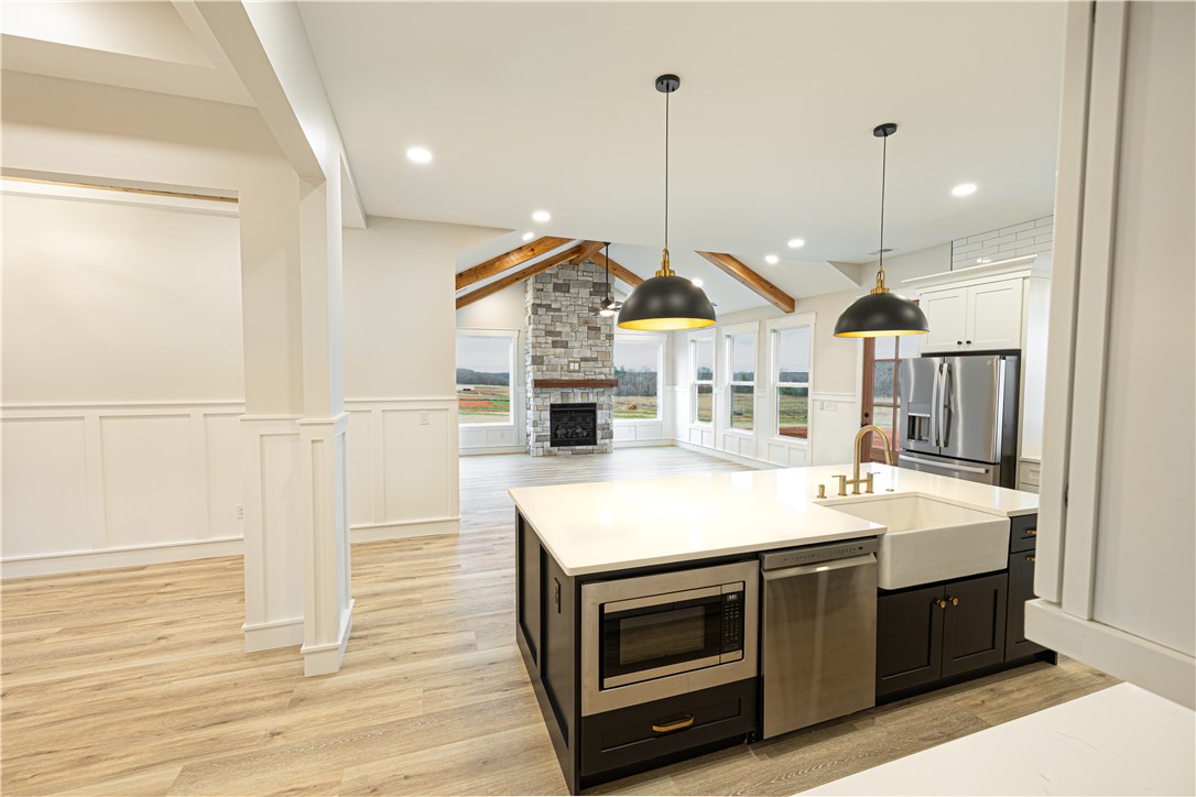 110 Hart Road Anderson, SC 29621 - Photo 24 of 31 This expansive open concept space features a kitchen island and a charming fireplace.