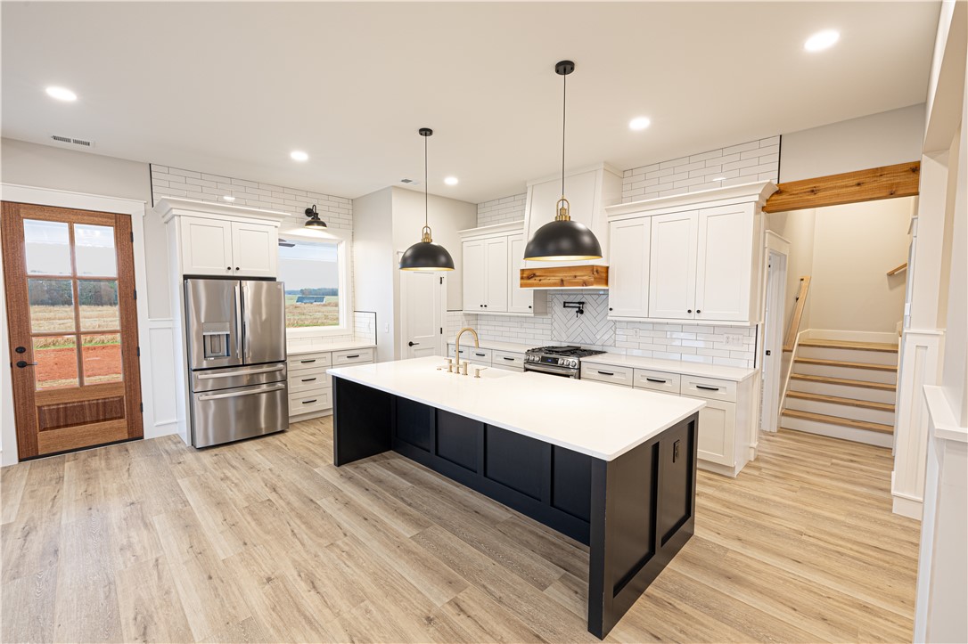 110 Hart Road Anderson, SC 29621 - Photo 28 of 31 This bright kitchen features modern appliances and a central island, perfect for culinary adventures and gatherings.