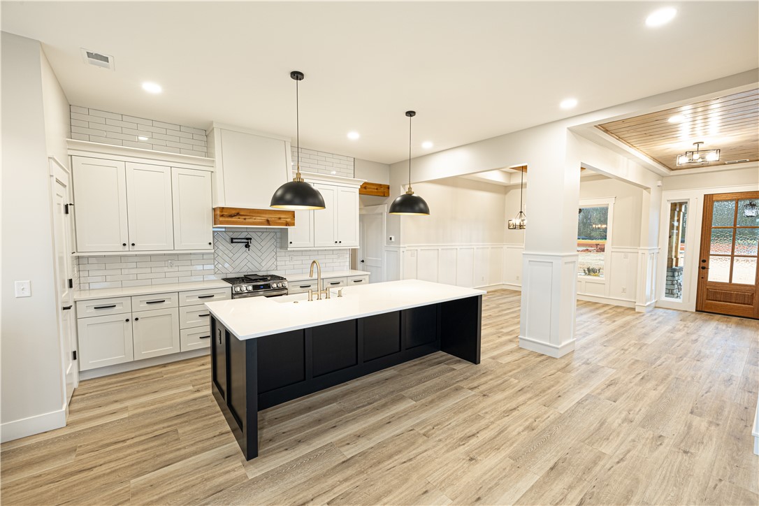 110 Hart Road Anderson, SC 29621 - Photo 9 of 31 This bright, open concept kitchen and living area features a kitchen island and natural wood flooring.