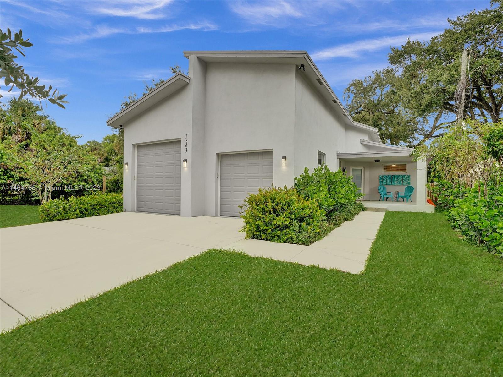 1543 Southwest 32nd Street Fort Lauderdale, FL 33315 - Photo 1 of 33 a house with green field in front of it