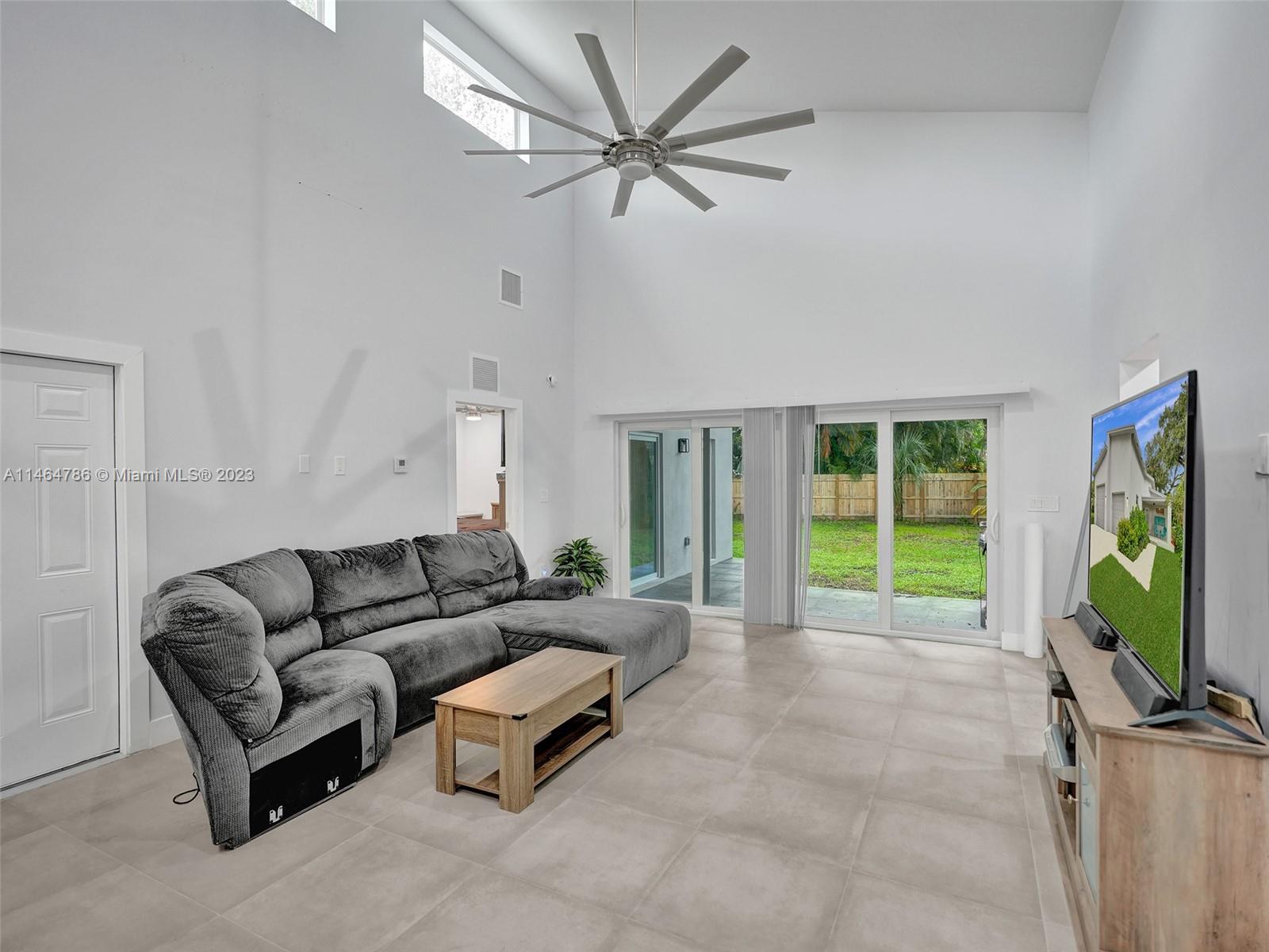 1543 Southwest 32nd Street Fort Lauderdale, FL 33315 - Photo 12 of 33 a living room with furniture tv and a flat screen tv
