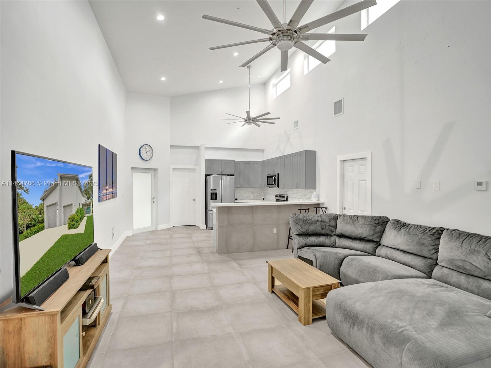 1543 Southwest 32nd Street Fort Lauderdale, FL 33315 - Photo 13 of 33 a living room with furniture and a flat screen tv