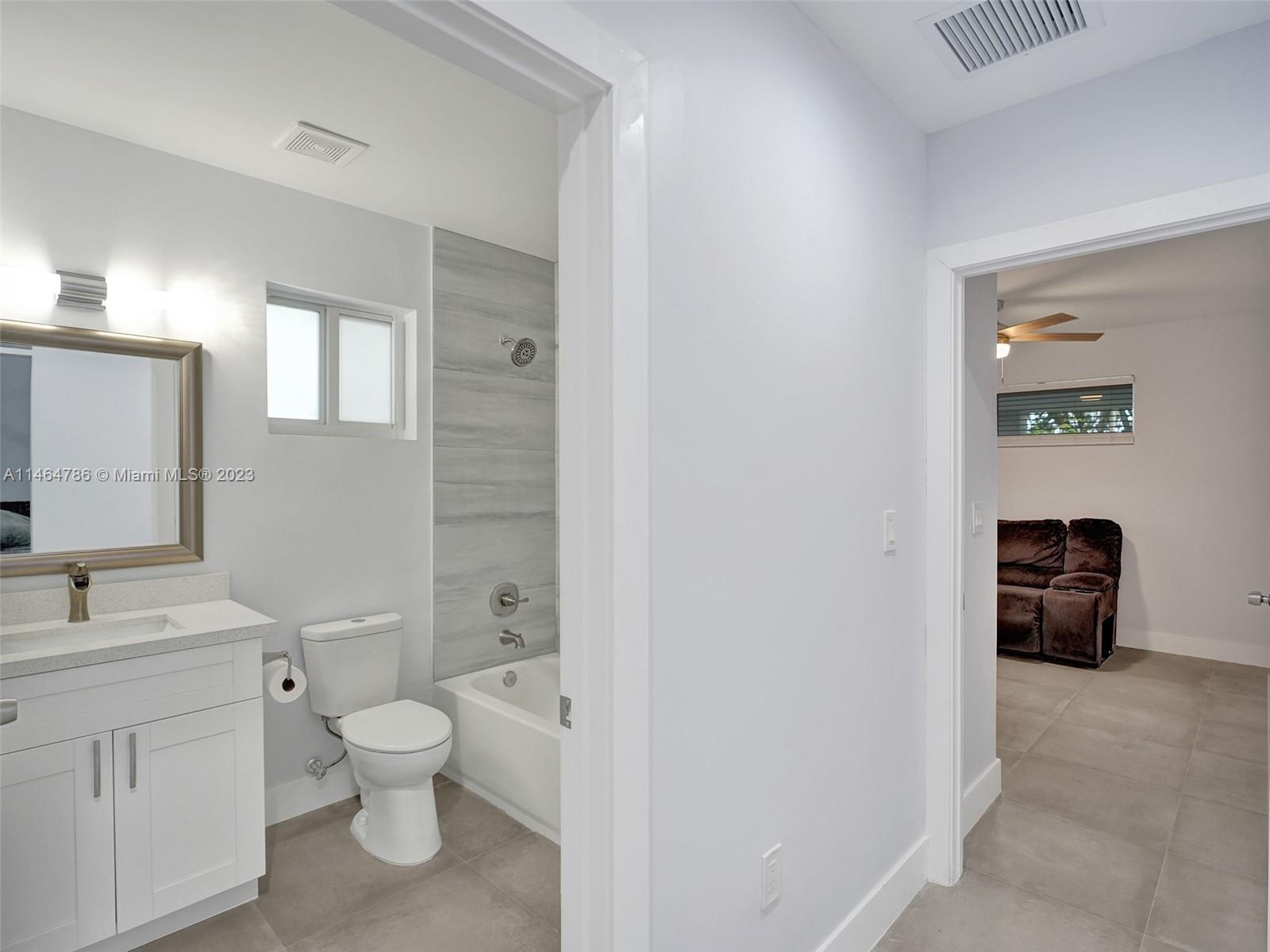 1543 Southwest 32nd Street Fort Lauderdale, FL 33315 - Photo 14 of 33 a bathroom with a toilet sink and a mirror
