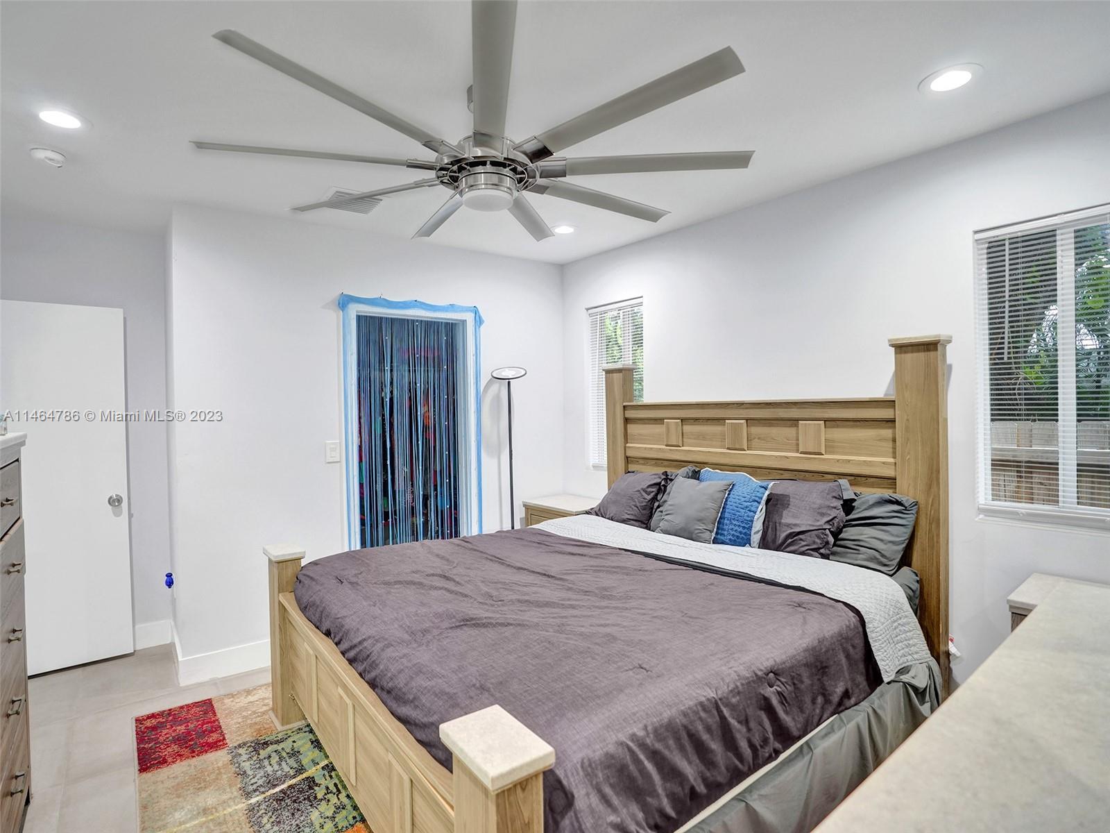 1543 Southwest 32nd Street Fort Lauderdale, FL 33315 - Photo 15 of 33 a bedroom with a large bed and a chandelier