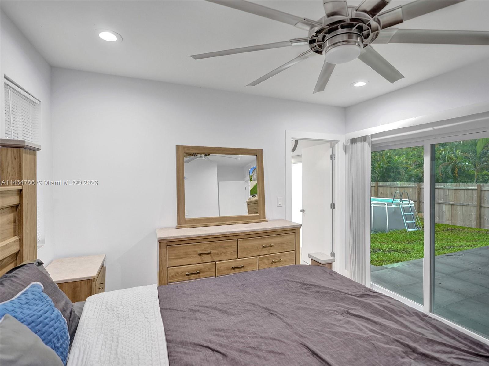 1543 Southwest 32nd Street Fort Lauderdale, FL 33315 - Photo 16 of 33 a living room with a bed furniture and a large window