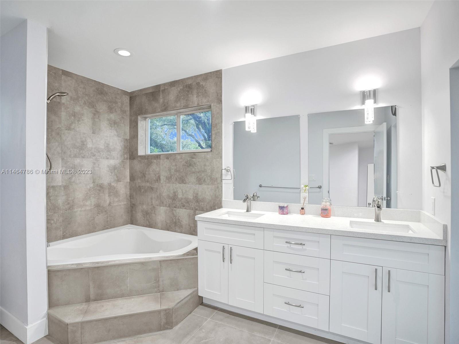 1543 Southwest 32nd Street Fort Lauderdale, FL 33315 - Photo 18 of 33 a bathroom with a double vanity sink mirror double and bathtub
