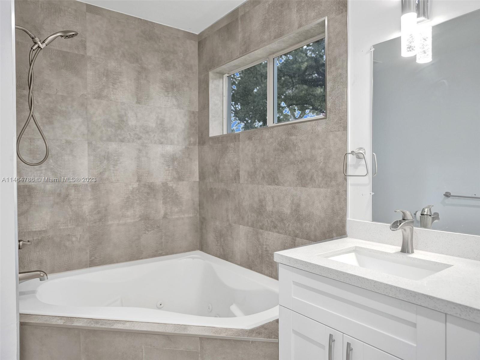 1543 Southwest 32nd Street Fort Lauderdale, FL 33315 - Photo 19 of 33 a white bath tub sitting next to a white sink and a shower