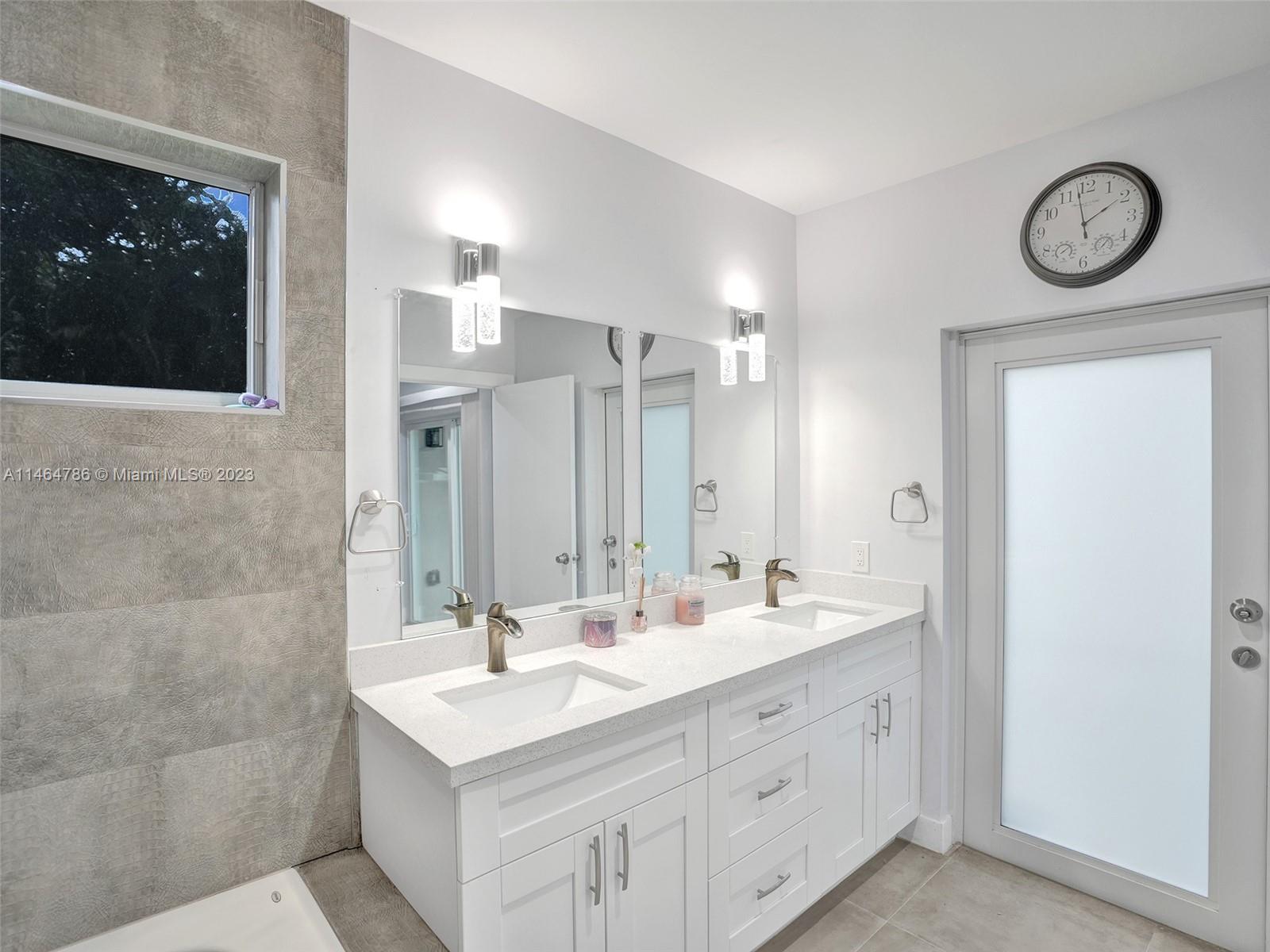 1543 Southwest 32nd Street Fort Lauderdale, FL 33315 - Photo 20 of 33 a bathroom with a sink a light fixture and a mirror