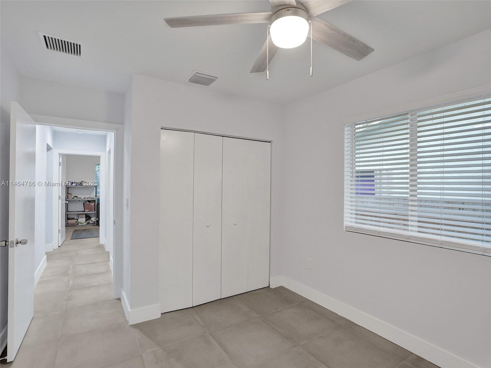 1543 Southwest 32nd Street Fort Lauderdale, FL 33315 - Photo 23 of 33 a view of an empty room with window chandelier fan