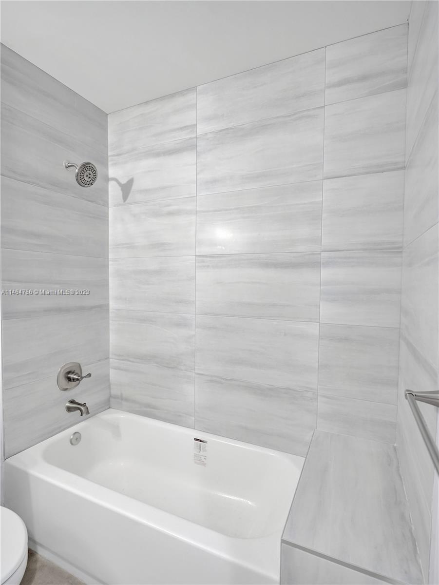 1543 Southwest 32nd Street Fort Lauderdale, FL 33315 - Photo 25 of 33 a bathroom with a bathtub and toilet