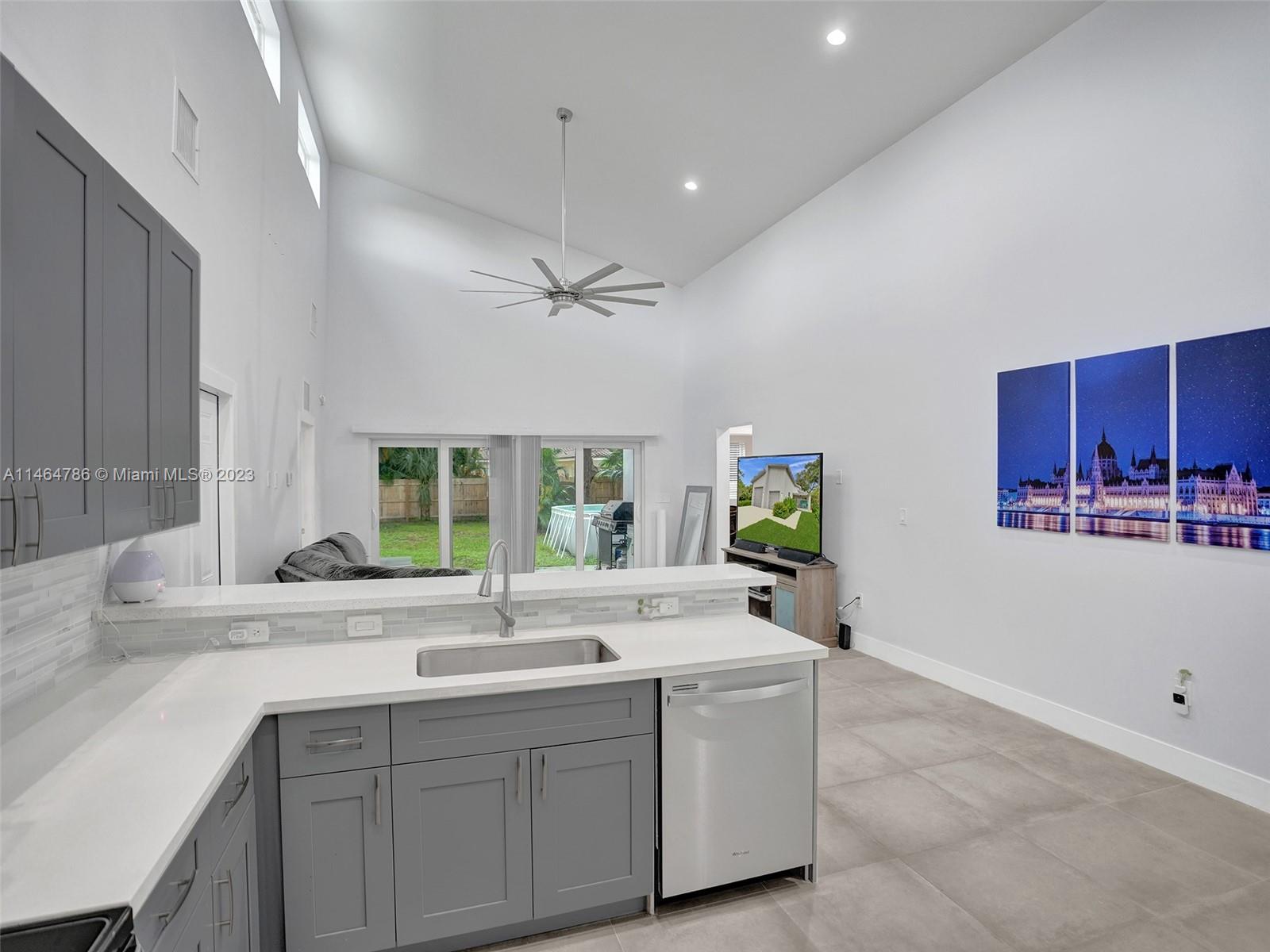 1543 Southwest 32nd Street Fort Lauderdale, FL 33315 - Photo 7 of 33 a large white kitchen with a sink and window