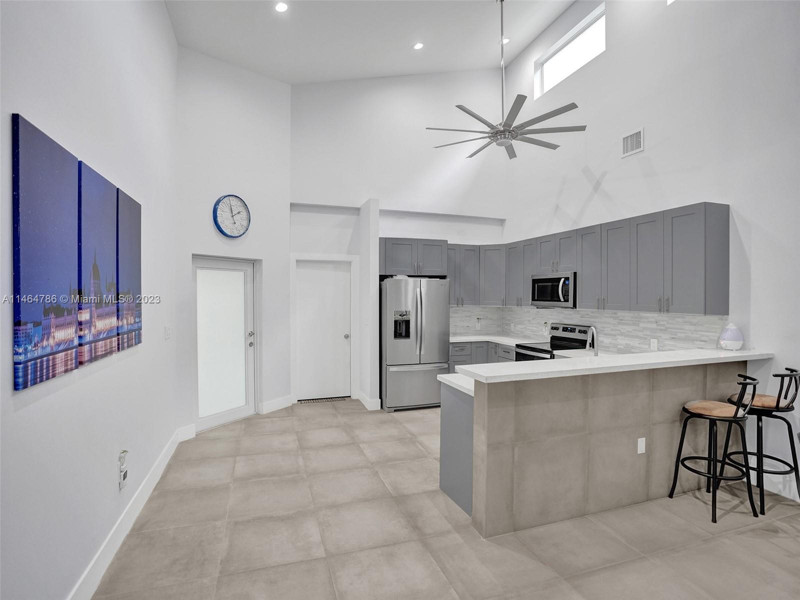 1543 Southwest 32nd Street Fort Lauderdale, FL 33315 - Photo 8 of 33 a kitchen with a cabinets a sink and stainless steel appliances