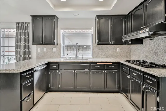 a kitchen with stainless steel appliances granite countertop a sink stove and cabinets