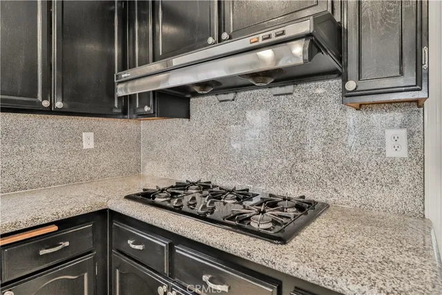 a kitchen with stainless steel appliances granite countertop a sink and cabinets