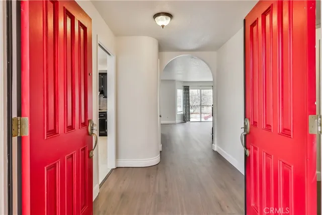 a view of a room with wooden floor and windows