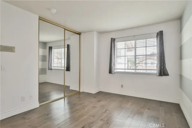 a bathroom with a granite countertop toilet sink and mirror