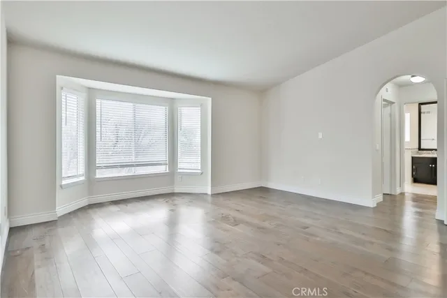 a bathroom with a glass shower door and a window