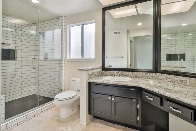 a view of a white house with a small yard and large tree