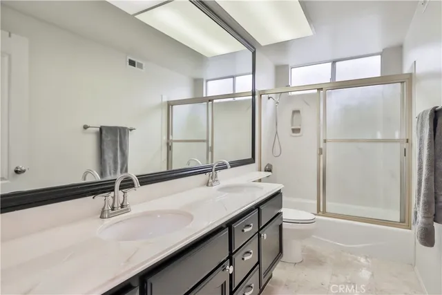 a view of a tennis ground with large trees