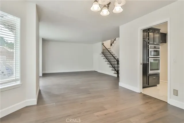 an empty room with windows and entryway