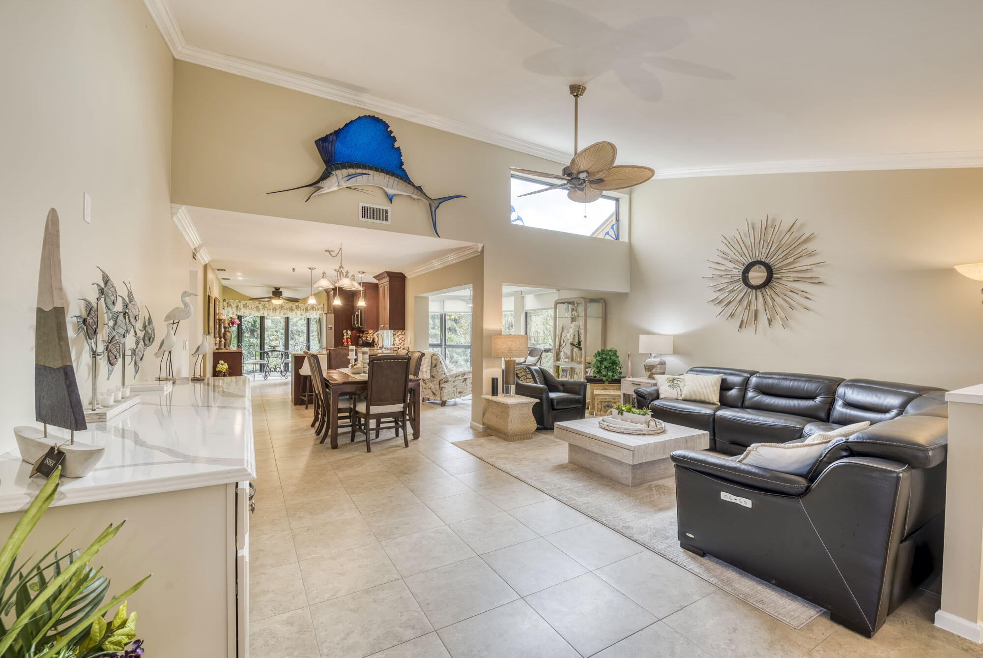 17165 Waterbend Drive, Unit 207 Jupiter, FL 33477 - Photo 1 of 27 a living room with furniture a chandelier and a dining table