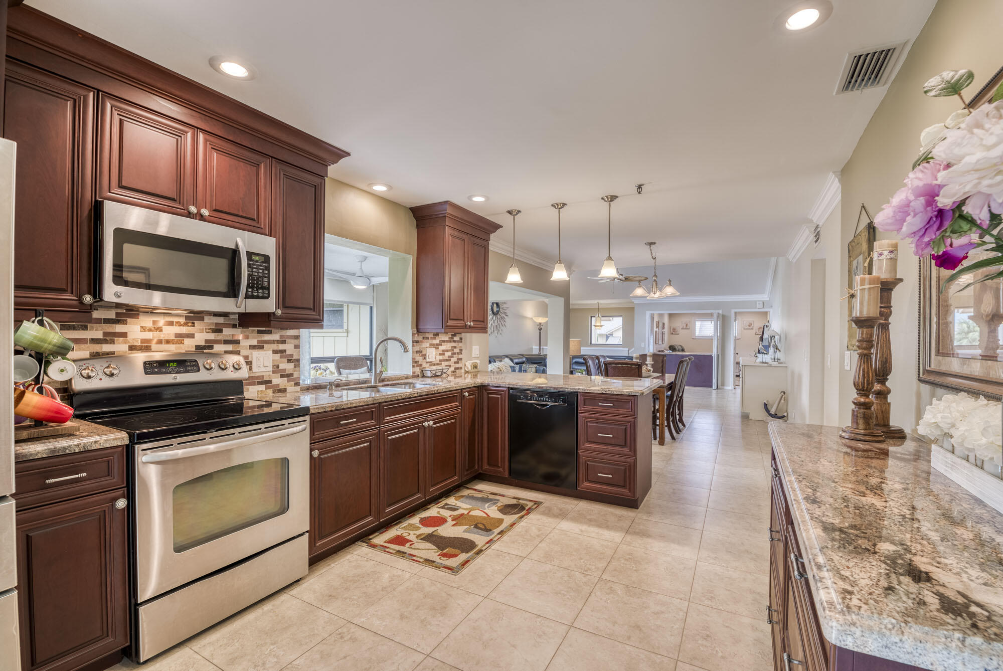 17165 Waterbend Drive, Unit 207 Jupiter, FL 33477 - Photo 12 of 27 a kitchen with a sink stove and oven