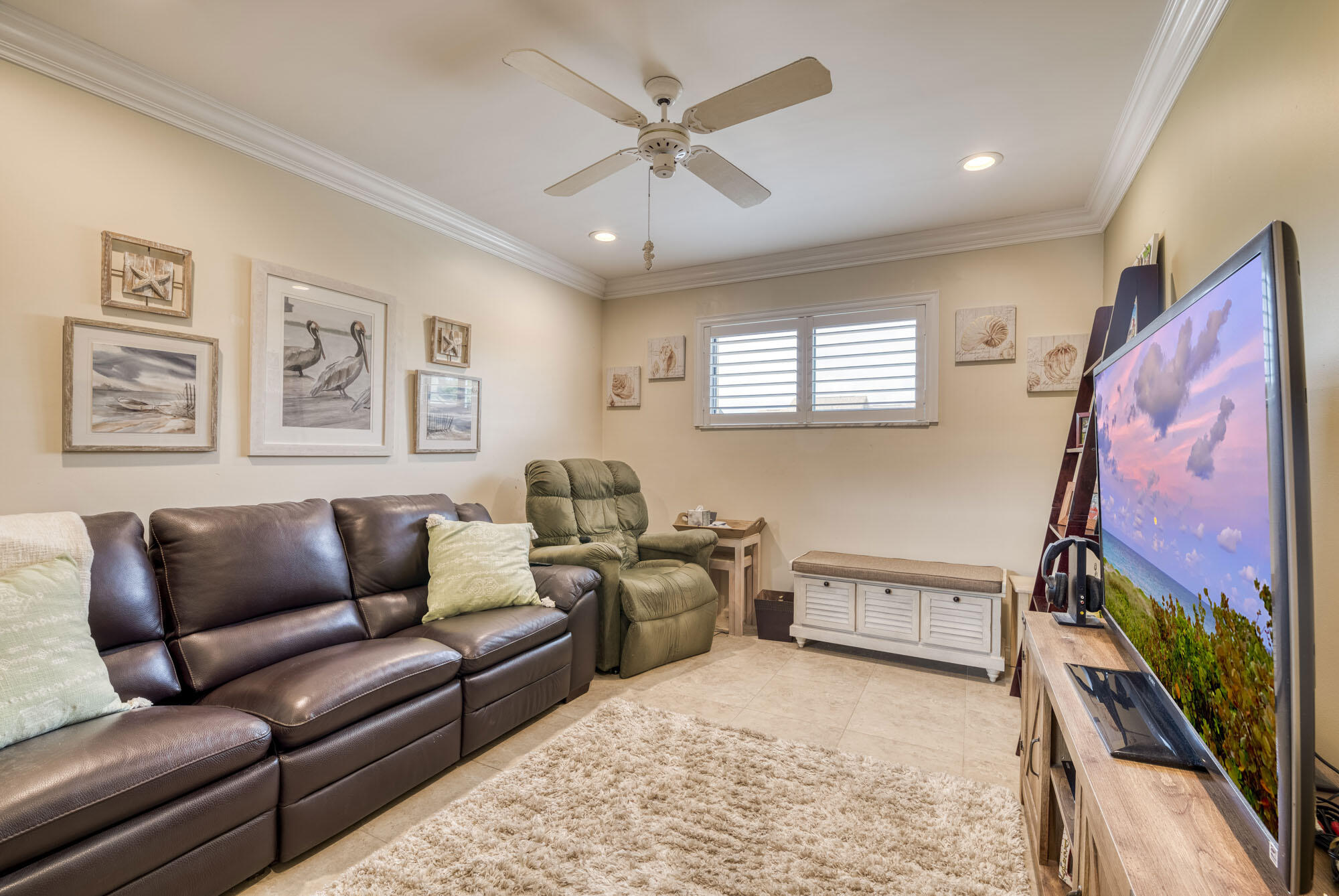 17165 Waterbend Drive, Unit 207 Jupiter, FL 33477 - Photo 16 of 27 a living room with furniture and a flat screen tv